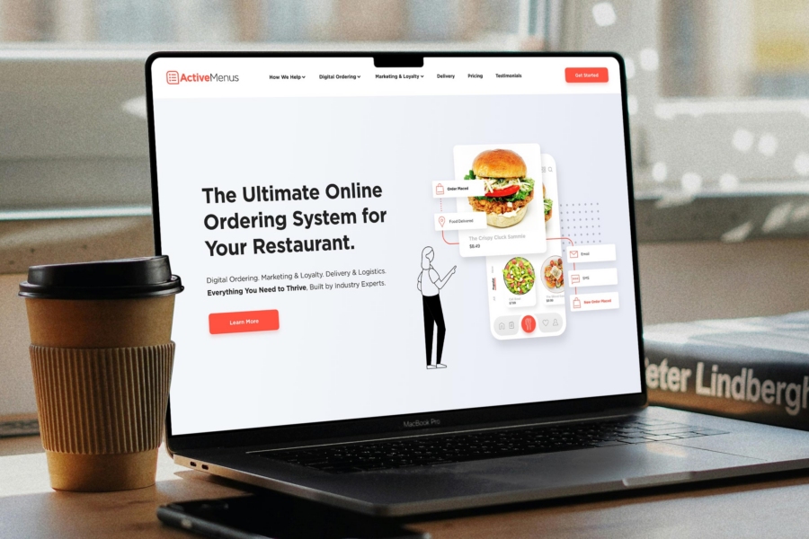 Website design for ActiveMenus software - homepage on laptop in cafe
